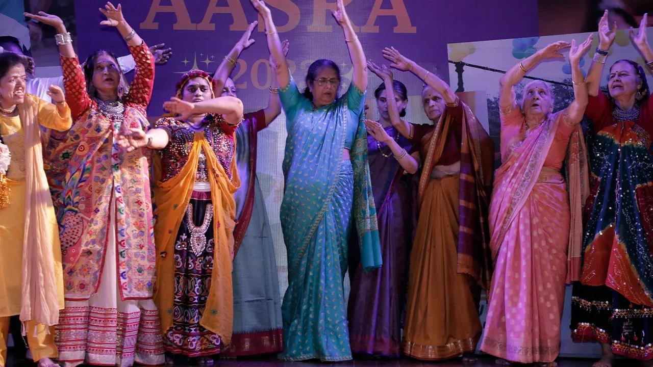 Elderly women dancing joyfully at Aasra