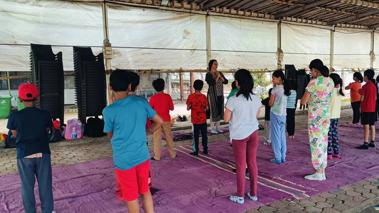 Children practising yoga and mindfulness during camp activities.